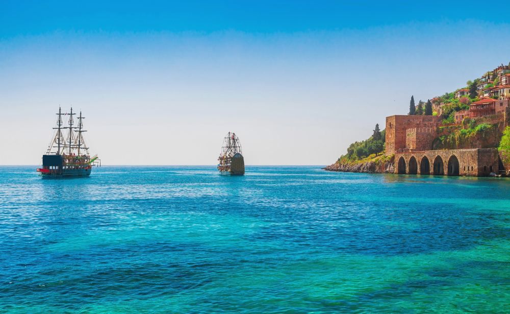 Scabies Treatment in Payallar | Online Prescription | Pirate boats in the bay with the Alanya shipyard and castle hill | E-rx.online