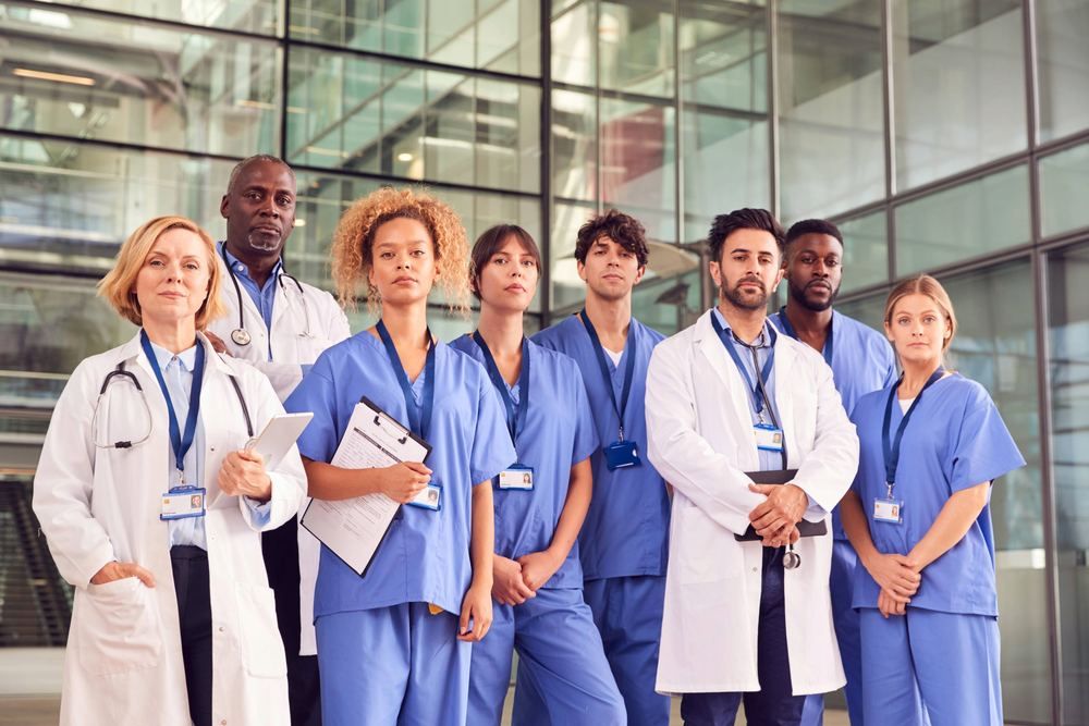 Team of doctors and nurses standing in a hospital lobby | Find a Doctor Near You in Bitez | Online Doctor & Online Prescription | E-rx.online