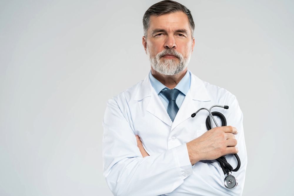 Need a Doctor in Fatih? Video Consultation and | Online Prescription | Experienced doctor in a white coat holding a stethoscope | E-rx.online